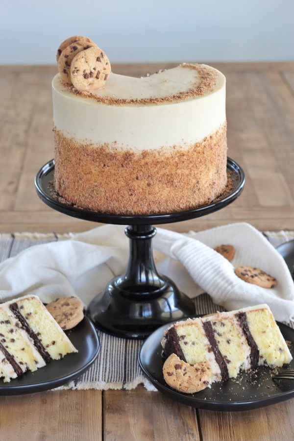 Cookie Cake: layers of yellow chocolate chip cake, baked on a chocolate cookie crust, with brown sugar frosting #cakebycourtney #cookiecake #easycakerecipe #layeredcake #chocolatechipcookiecake
