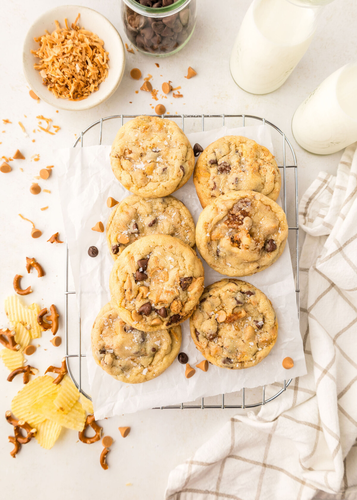 A plate of cookies with milk and ingredients next to it.