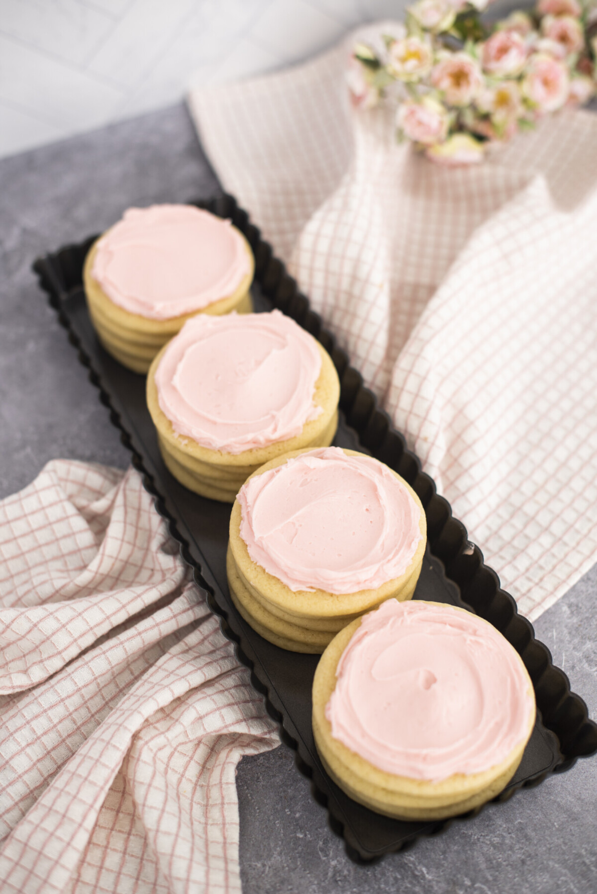A row of sugar cookies in a tin pan.