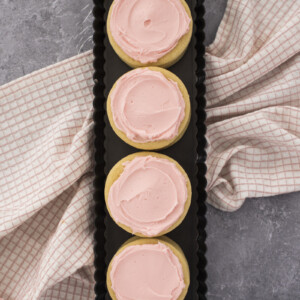 Pink sugar cookies in a row.