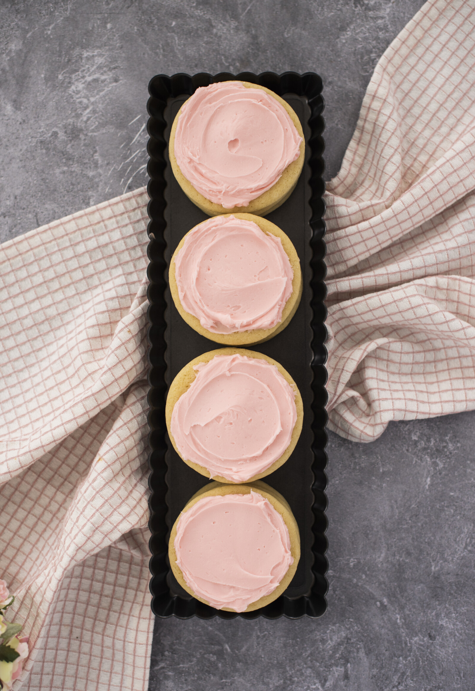 Pink sugar cookies in a row.