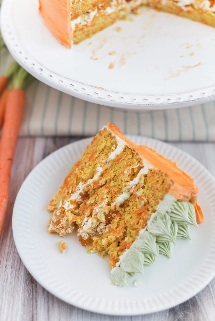 Carrot Apricot Cake - carrot ginger cake layers with white chocolate buttercream, apricot filling and a pretzel crunch #cakebycourtney #carrotcake #whitechocolatebuttercream #cake #eastercake #carrotcakeforeaster #easterdessert