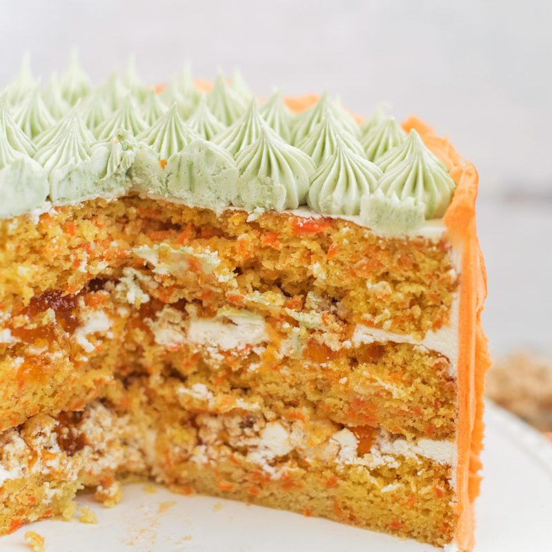 Carrot Apricot Cake - carrot ginger cake layers with white chocolate buttercream, apricot filling and a pretzel crunch #cakebycourtney #carrotcake #whitechocolatebuttercream #cake #eastercake #carrotcakeforeaster #easterdessert