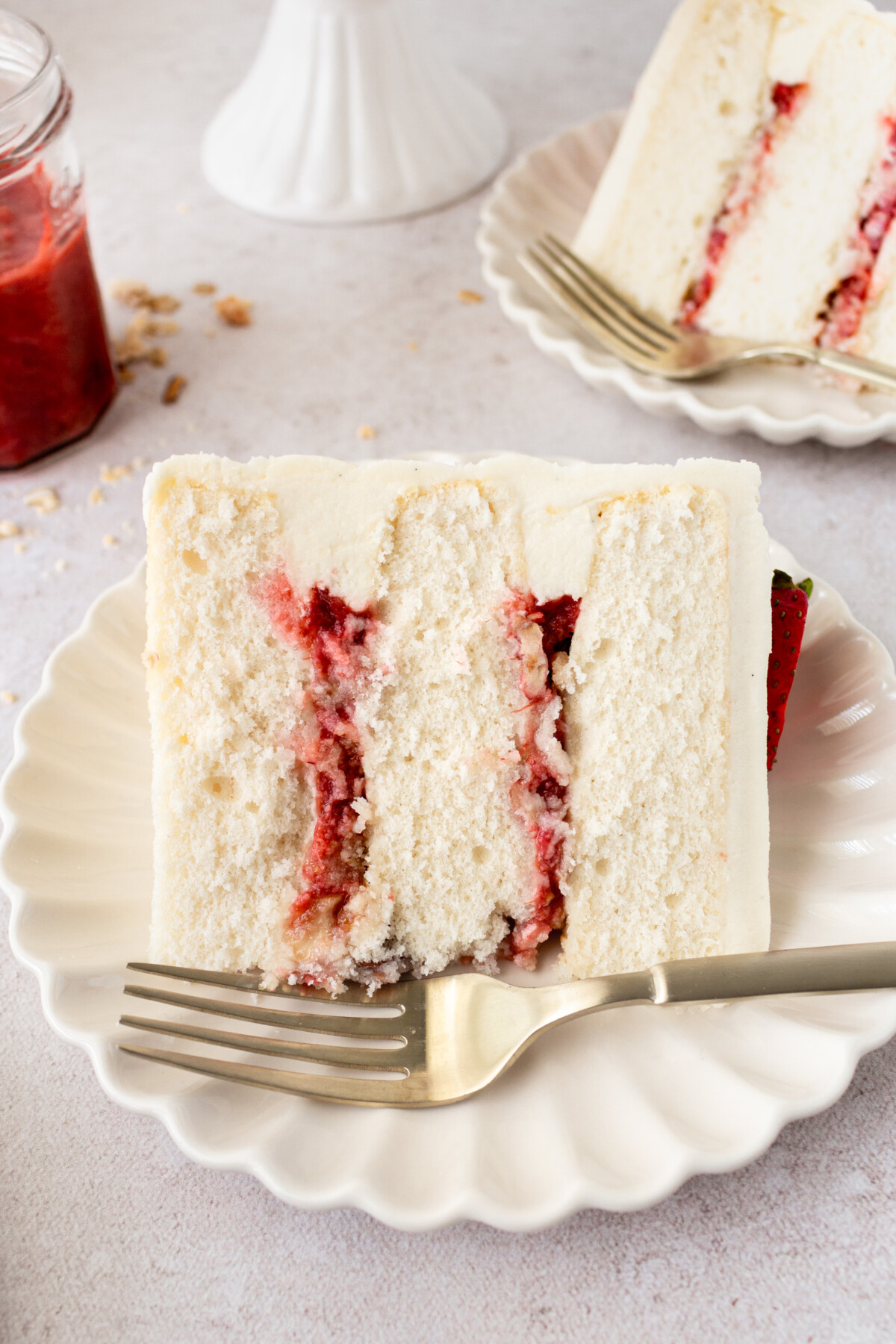 A slice of cake on a plate with a fork.