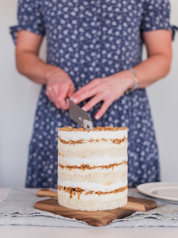 Woman cutting into a cake.