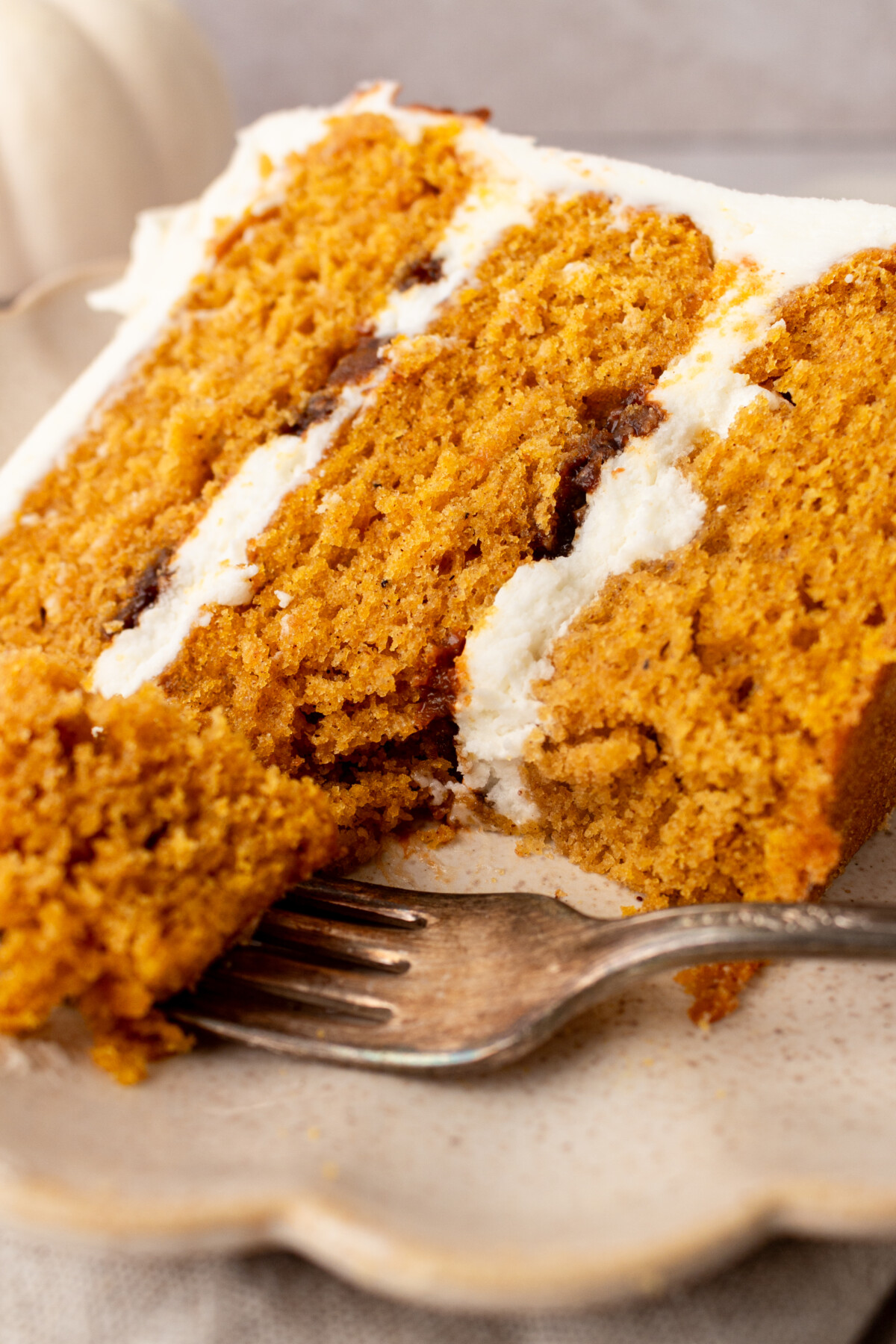 A slice of cake with a bite taken out of it on a fork.