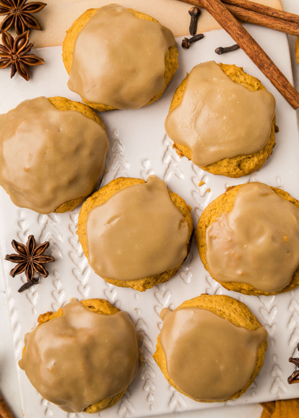 Pumpkin cookies on a cutting board.