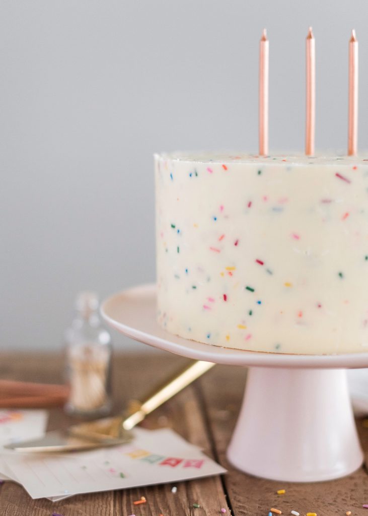 Classic Confetti Cake - tender and fluffy vanilla cake layers, filled with sprinkles and covered with a whipped vanilla buttercream. #confetticake #birthdaycake #bestbirthdaycake #funfetticake #birthdaycakerecipe #vanillabuttercream #cakebycourtney