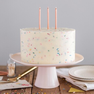 Classic Confetti Cake - tender and fluffy vanilla cake layers, filled with sprinkles and covered with a whipped vanilla buttercream. #confetticake #birthdaycake #bestbirthdaycake #funfetticake #birthdaycakerecipe #vanillabuttercream #cakebycourtney