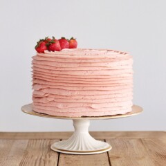 A light pink ombre style cake with textured buttercream