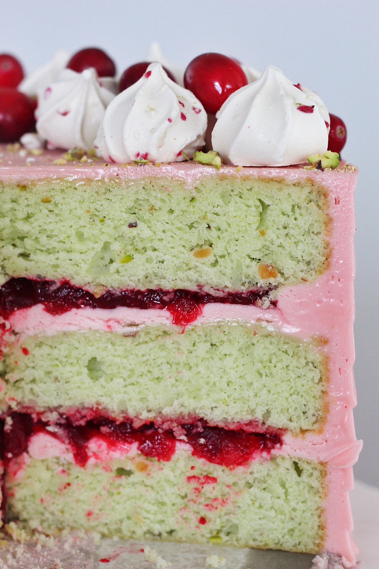 Inside view of a pistachio cake with cranberry compote.