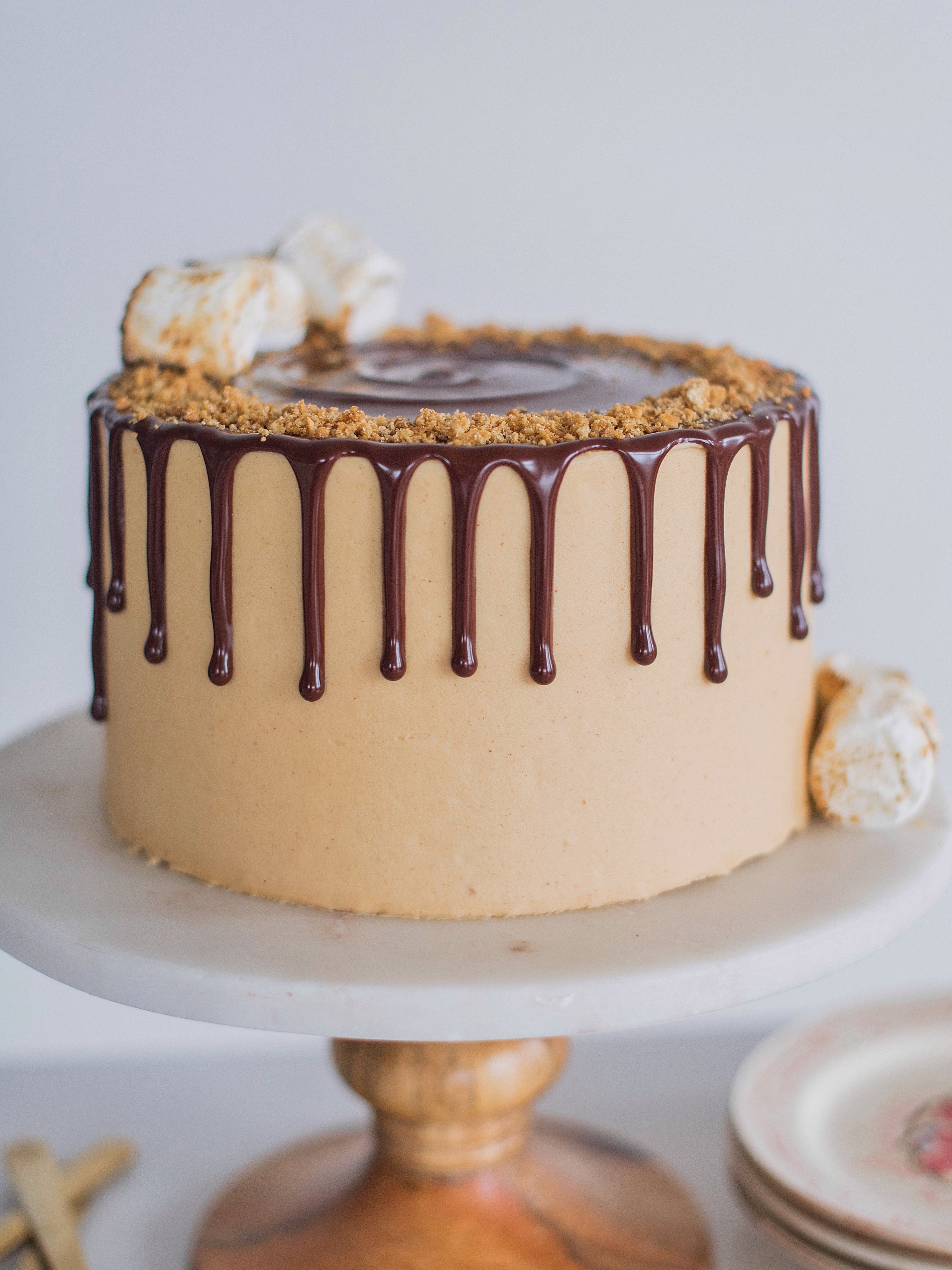 The ultimate s'mores cake for peanut butter lovers! Graham cracker cake layers with a toasted marshmallow filling, toasted graham crackers, chocolate ganache and peanut butter buttercream. 