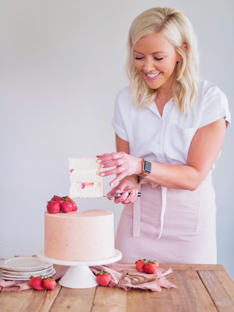 Strawberry Shortcake: Tender and fluffy layers of vanilla cake, filled with whipped cream and fresh strawberries, and covered in a strawberry buttercream.  #cakebycourtney #cake #cakerecipe #strawberryshortcake #shortcake #strawberry #buttercream