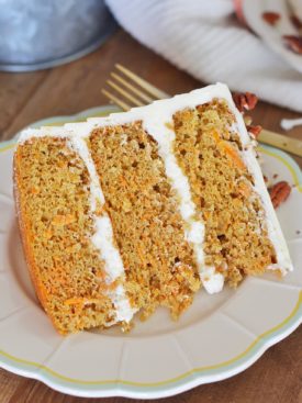 Classic Carrot Cake: incredibly moist, spiced carrot cake layers with a perfectly tangy cream cheese buttercream. #CakebyCourtney #carrotcake #classiccarrotcake #carrotcakewithoutraisins #carrotcakewithoutnuts #carrotcakewithoutnutsorraisins #creamcheesefrosting #creamcheesebuttercream #carrotcakerecipe #thebestcarrotcakerecipe #thebestcarrotcake #eastercake #easterrecipe #easterdessert