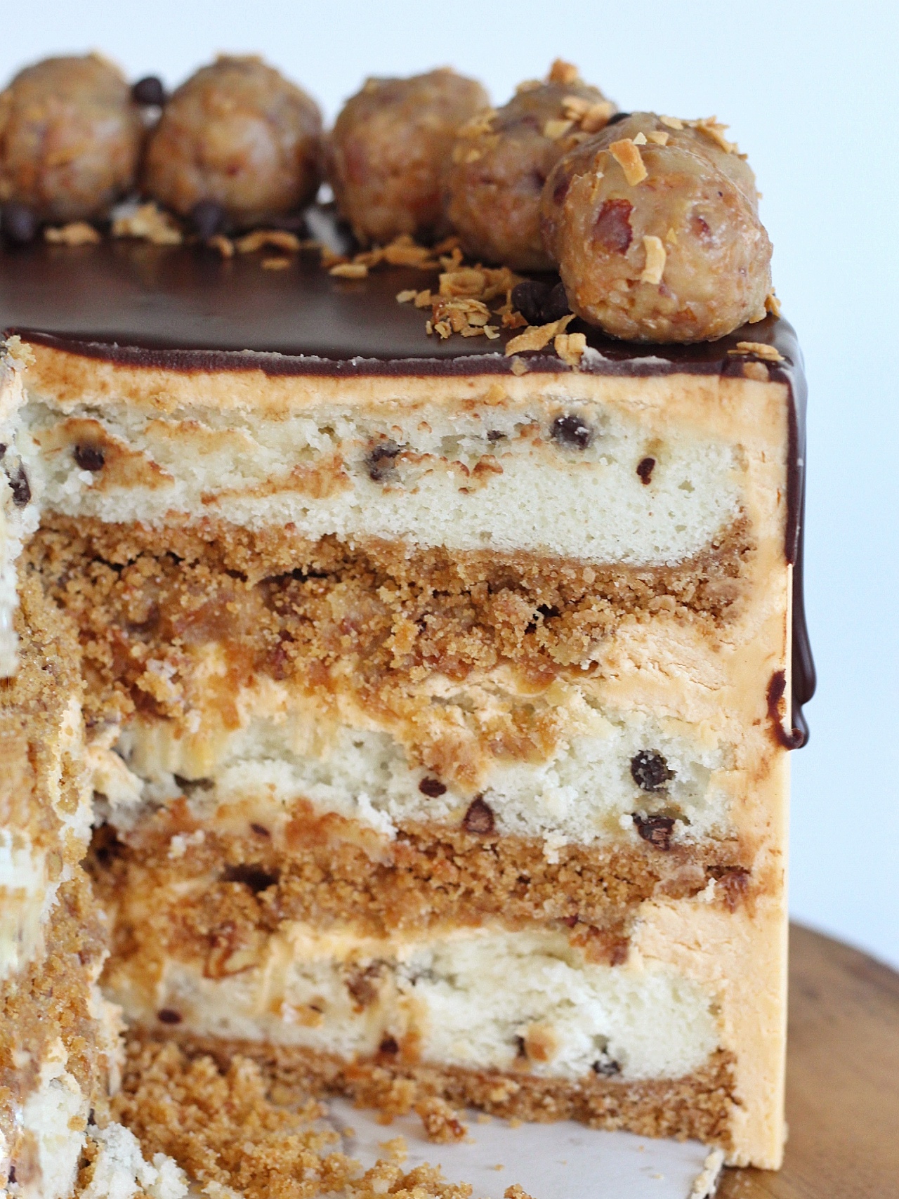 Seven Layer Bar Cake: inspired by a 7 layer bar, this Seven Layer Bar Cake is made up of graham cracker crust, coconut chocolate chip cake layers, a buttery, gooey coconut and pecan filling and a butterscotch buttercream. #sevenlayerbar #7layerbar #magicbars #sevenlayerbarcake #7layerbarcake #cake #layeredcake #birthdaycake #cakebycourtney