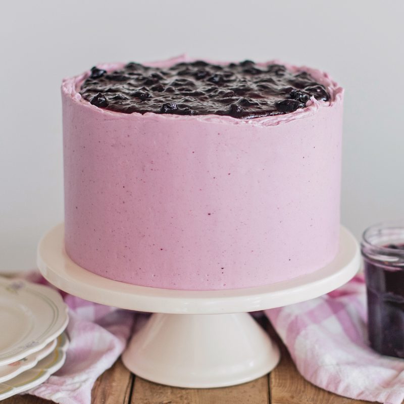 Blueberry Delight Cake - Nilla wafer crust, lemon ricotta cake layers, ricotta filling, blueberry compote and blueberry buttercream. #cakebycourtney #cake #blueberrydelightcake #stackingcakes #caketutorial #cakedecoratingtutorial #blueberry #summercake #summerdessert #blueberrydessert