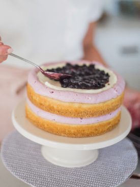How to Stack a Cake: Blueberry Delight Cake - Nilla wafer crust, lemon ricotta cake layers, ricotta filling, blueberry compote and blueberry buttercream. #cakebycourtney #cake #blueberrydelightcake #stackingcakes #caketutorial #cakedecoratingtutorial #blueberry #summercake #summerdessert #blueberrydessert #howtostackacake