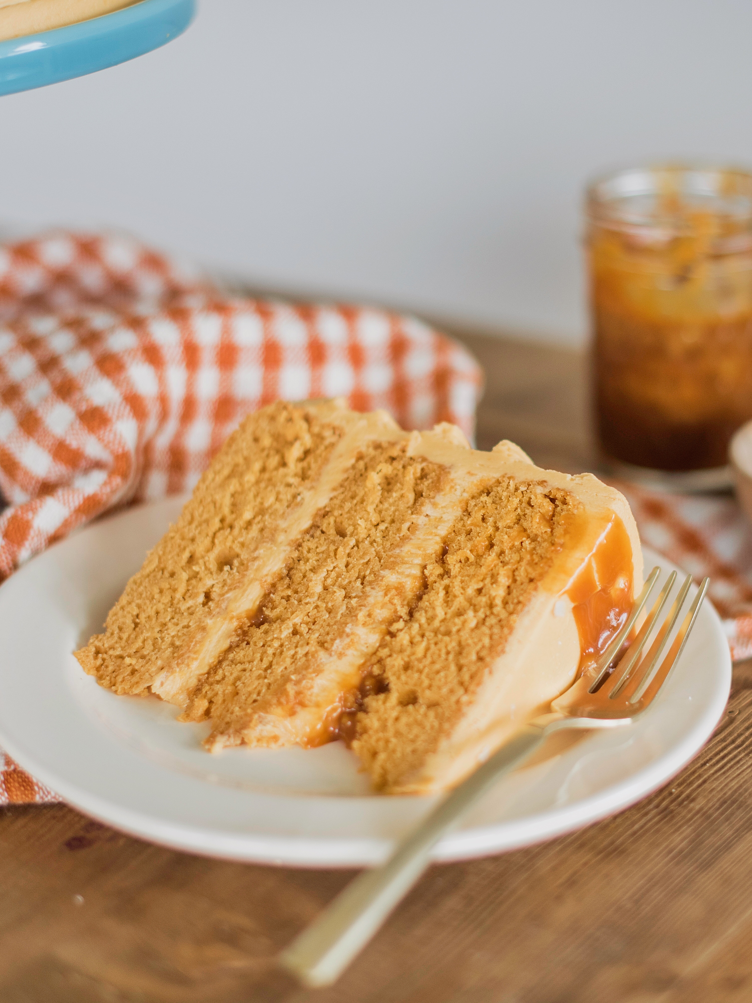 Caramel layered cake on a plate with a fork.