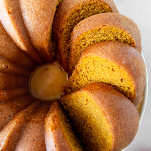 Pumpkin bundt cake with slices cut into it.