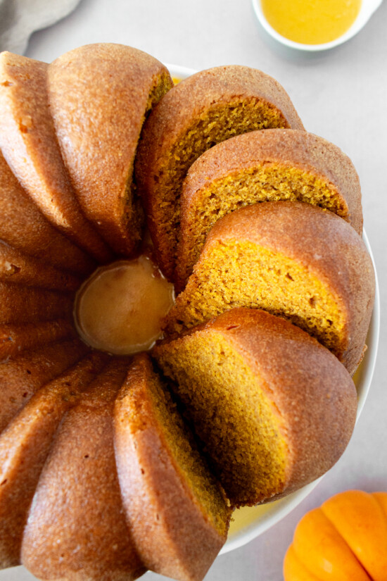 Pumpkin bundt cake with slices cut into it.