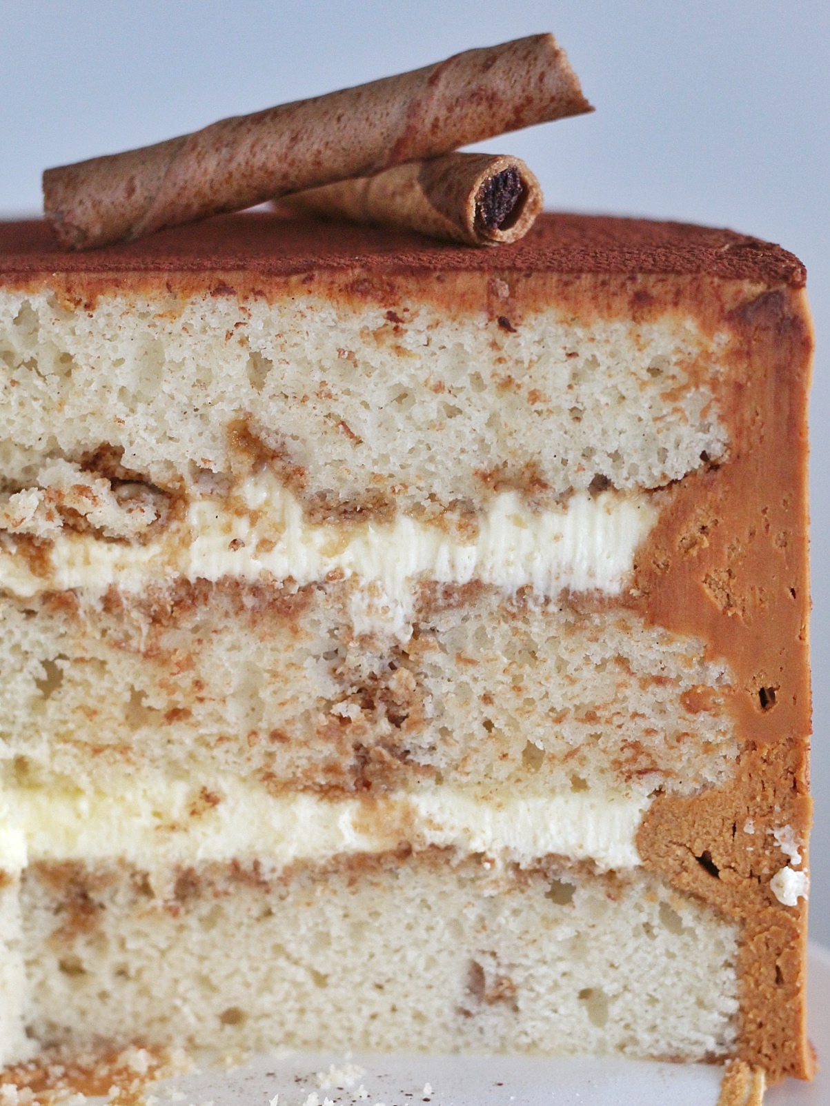 Tiramisu Cake - vanilla bean cake layers with a coffee and rum soak, mascarpone custard and coffee buttercream. #cakebycourtney #tiramisu #tiramisucake #tiramisucakerecipe #tiramisurecipe #cakerecipe #howtomakeatiramisu #coffeebuttercream #buttercreamrecipe #cakerecipe #layeredcake #coffeecake #custardrecipe