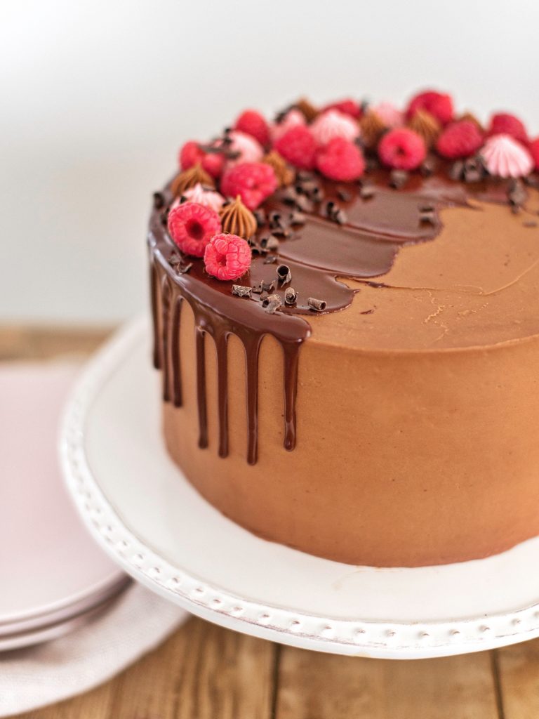 Raspberry Chocolate Truffle Cake - layers of chocolate cake, raspberry cream, chocolate ganache, raspberry cake and chocolate buttercream #cakebycourtney #valentinescake #valentinesdessert #bestcake #raspberrycake #raspberrychocolatecake #chocolatecake #chocolatebuttercream #raspberrycreamfilling #cake #cakerecipe #valentinescakerecipe #bestdessertrecipe #bestcakerecipe