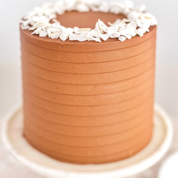 Chocolate Coconut Cake - coconut cake layers with a chocolate coconut buttercream #cakebycourtney #cake #coconutcake #chocolatecoconutcake #cakerecipe #easycakerecipe #chocolatebuttercream #easycoconutcakerecipe #coconutcakerecipe