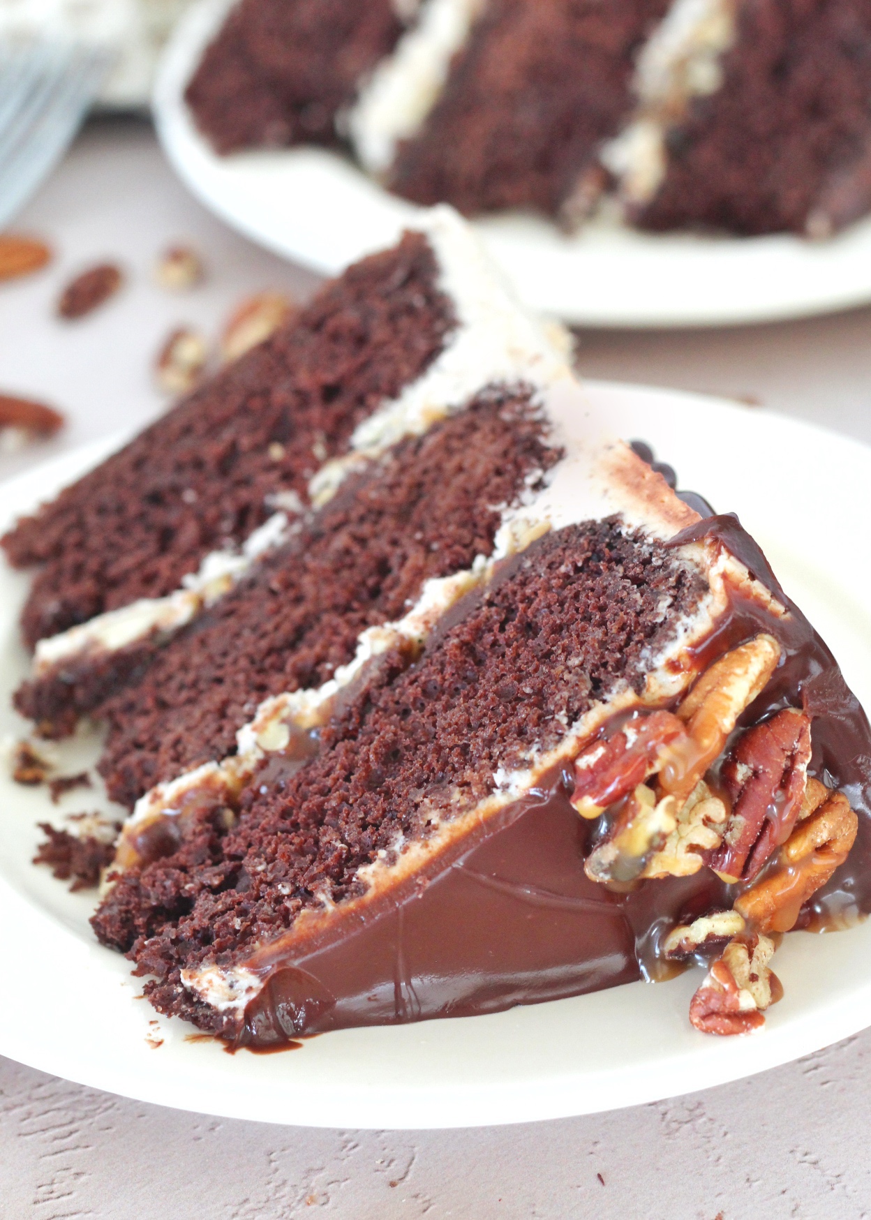 Turtle Pie Cake - rich and tender chocolate cake layers with salted caramel, toasted pecans, chocolate ganache and pecan buttercream #cakebycourtney #pecan #turtlepie #turtlepiecake #turtlepiecakerecipe #turtlepierecipe #chocolatecake #thebestturtlepiecake #thebestturtlepie