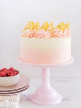Coconut Lemon Raspberry Cake - coconut cake layers, lemon curd, raspberry cream filling, and coconut buttercream. #cakebycourtney #coconutcake #bestcoconutcake #lemoncurd #raspberrycream #raspberryfilling #coconutbuttercream #summercake #bestsummerdessertrecipes #summercakes #summerdessertrecipes