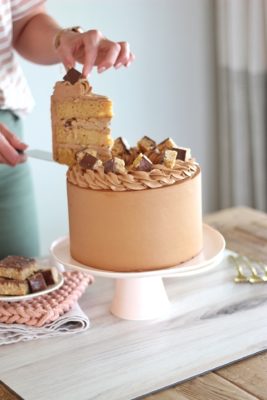 Scotcheroo Cake - caramel peanut butter cake layers with chocolate butterscotch buttercream #cake #cakerecipe #scotcheroo #scotcheroocake #scotcheroorecipe