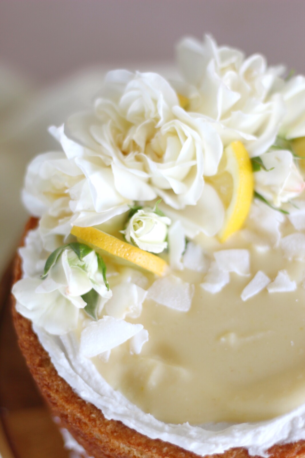 Sweet Laurel Bakery Fluffy Lemon Coconut Cake - lemon coconut cake layers, coconut spread and lemon curd #grainfreecake #dairyfreecake #refinedsugarfreecake #healthycake #lowsugarcake #glutenfreecake #glutenfreedessert #sweetlaurelbakery #lemoncoconutcake #lemoncurd #cakebycourtney