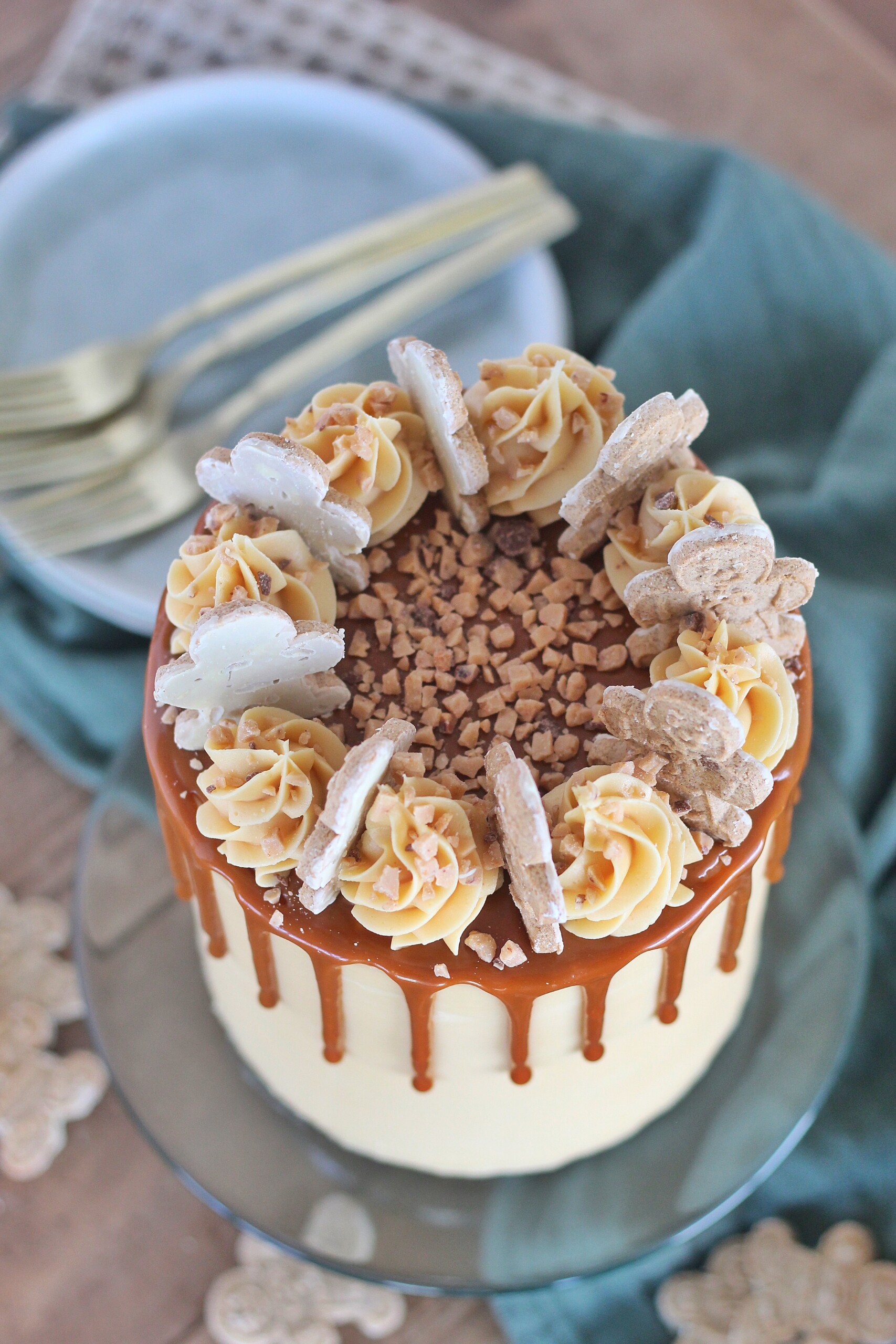 Swirls of caramel buttercream, caramel drip and toffee bits covering tender and moist gingerbread cake layers