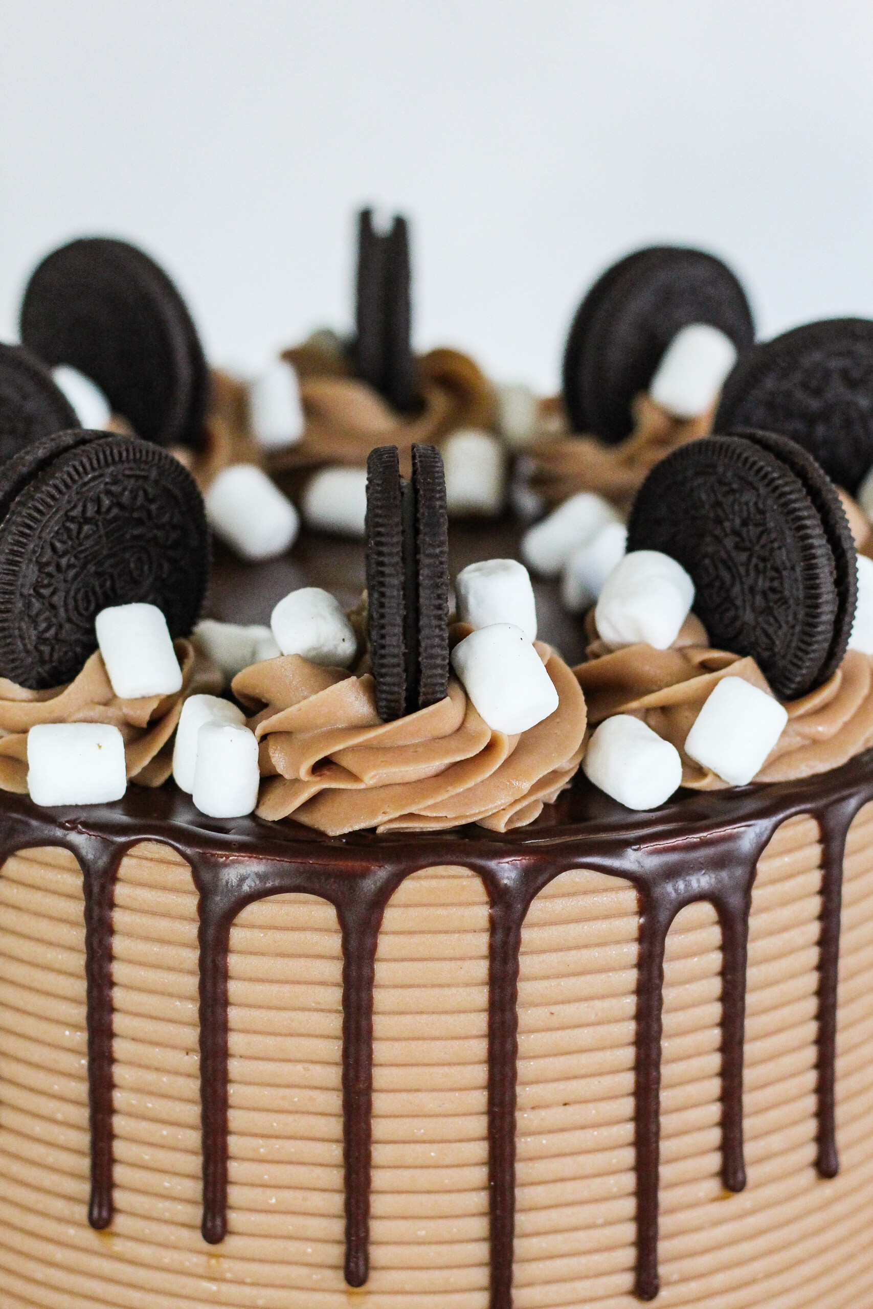 Oreo cookies on a cake with a drip.
