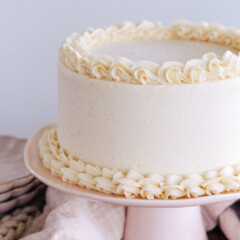 Brown Butter Cake on a light pink cake stand.