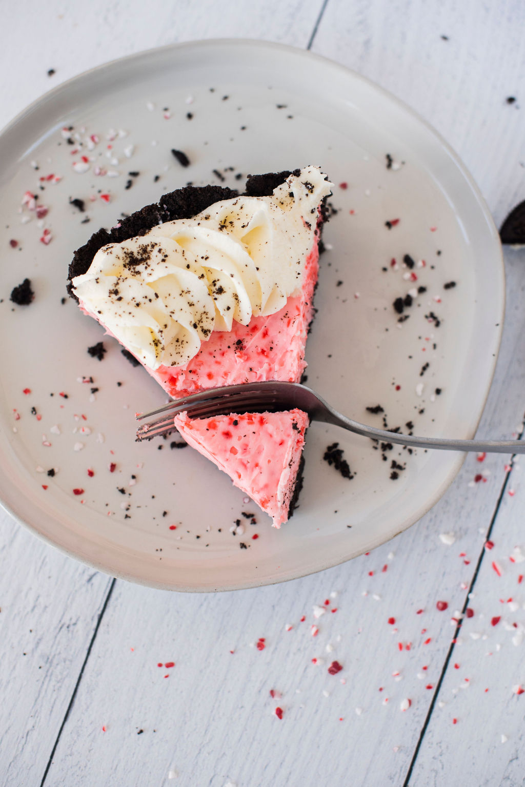 A slice of peppermint Oreo pie with a fork.