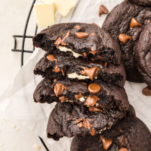 Chocolate cookies split in half on a cooling rack.