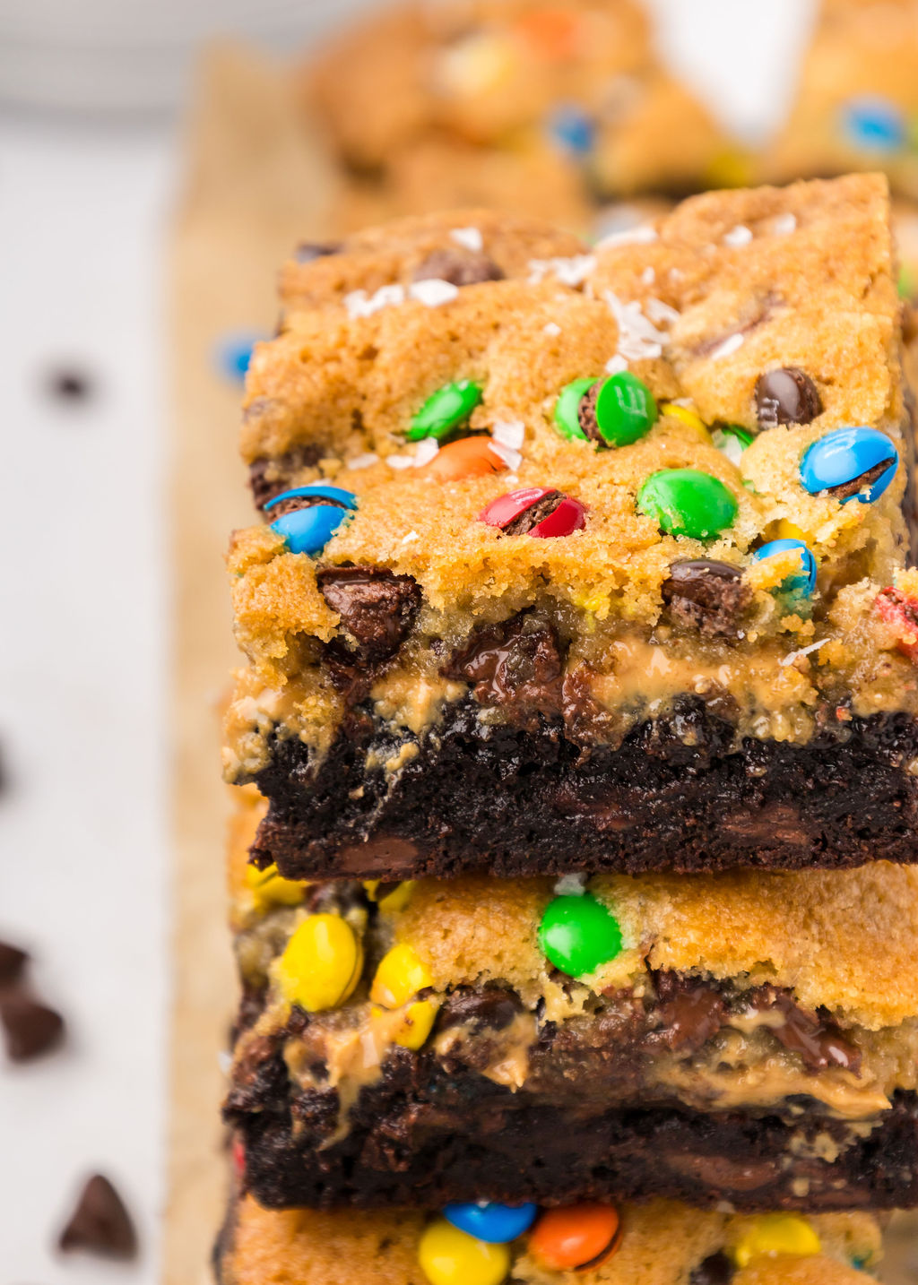 A stack of Monster Brookie Bars on a cutting board.