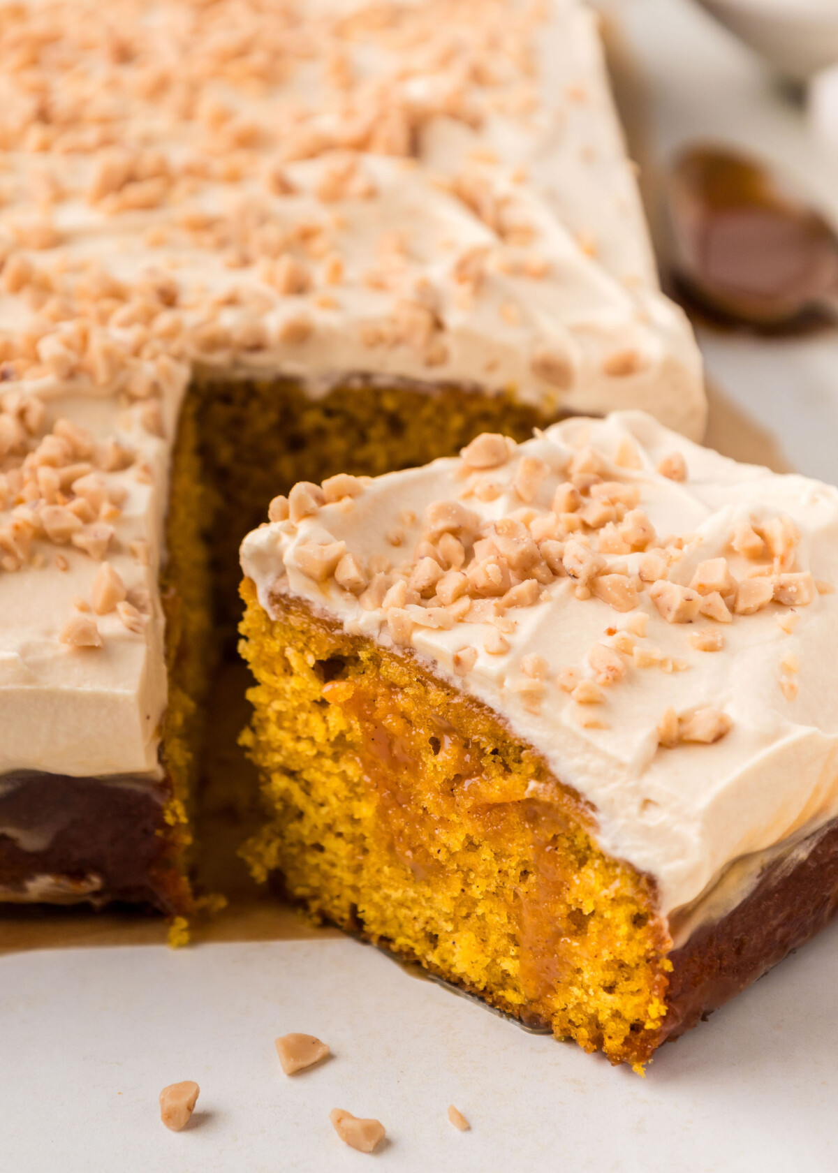 A slice of cake removed from a sheet cake.