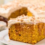 A slice of pumpkin poke cake on a plate.