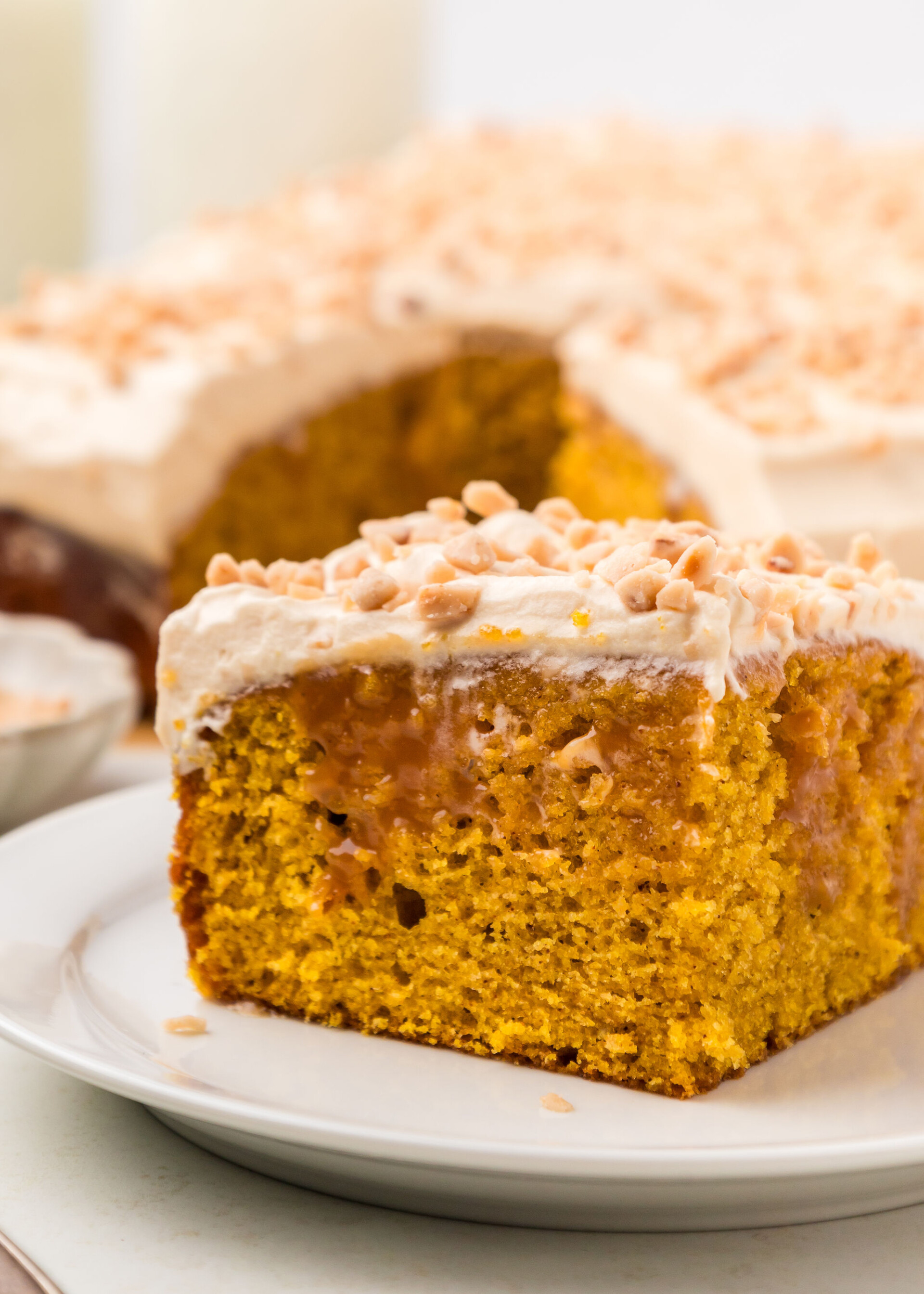 A slice of pumpkin poke cake on a plate.