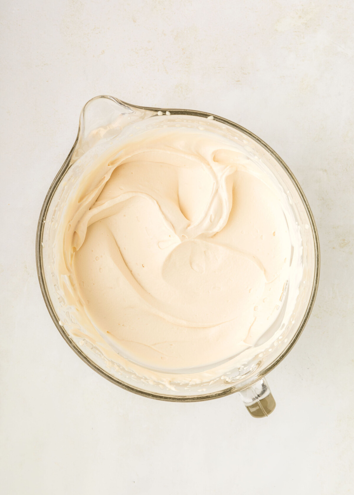 Caramel whipped cream in a mixing bowl.