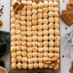 An overhead view of a sheet cake on a cutting board.