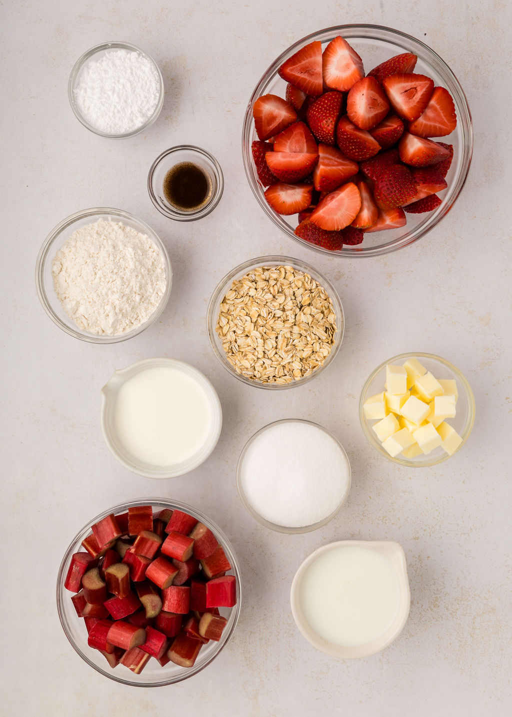 Ingredients for a strawberry rhubarb crumble on the counter.