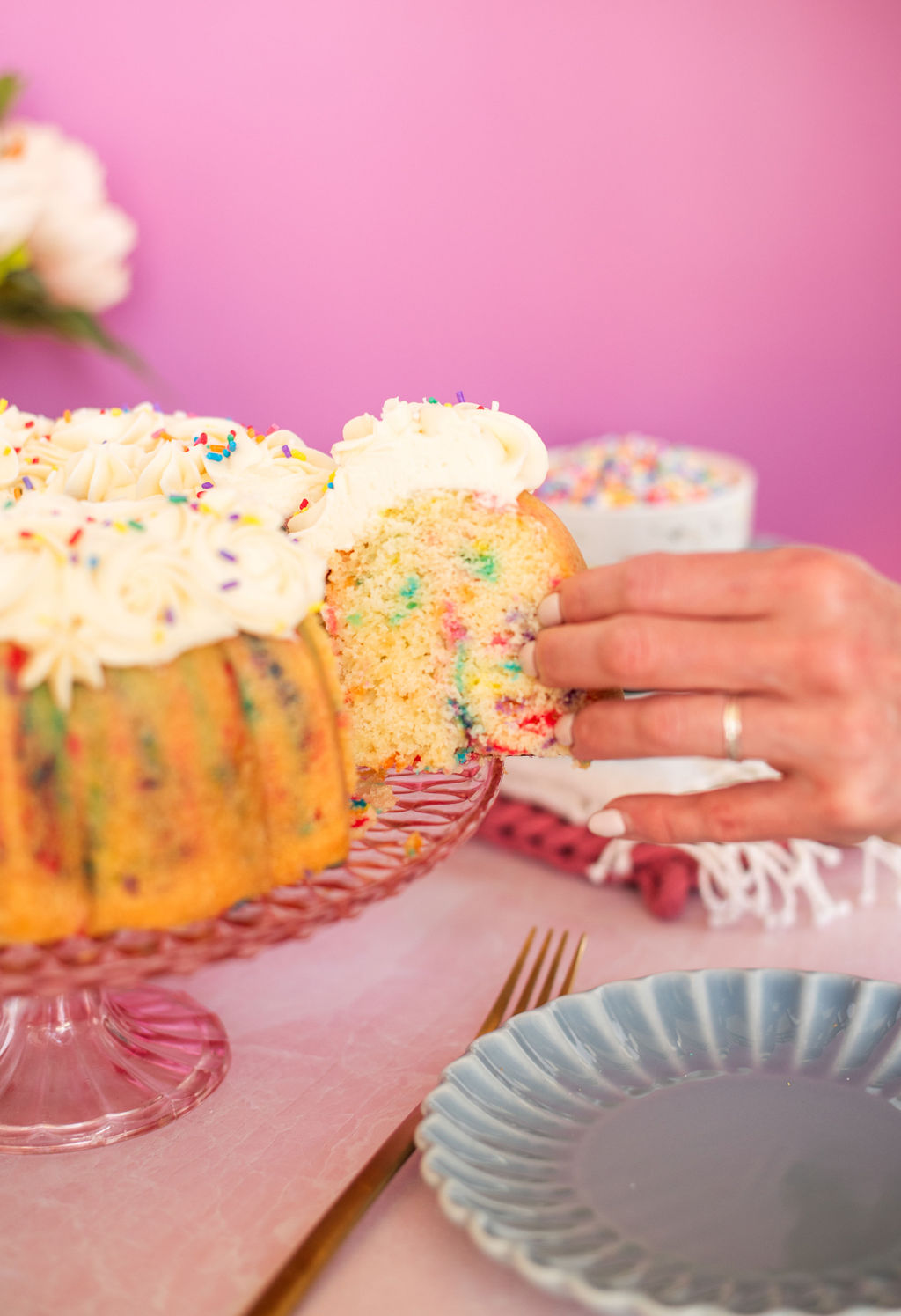 Woman taking a slice of cake out of a bundt cake.