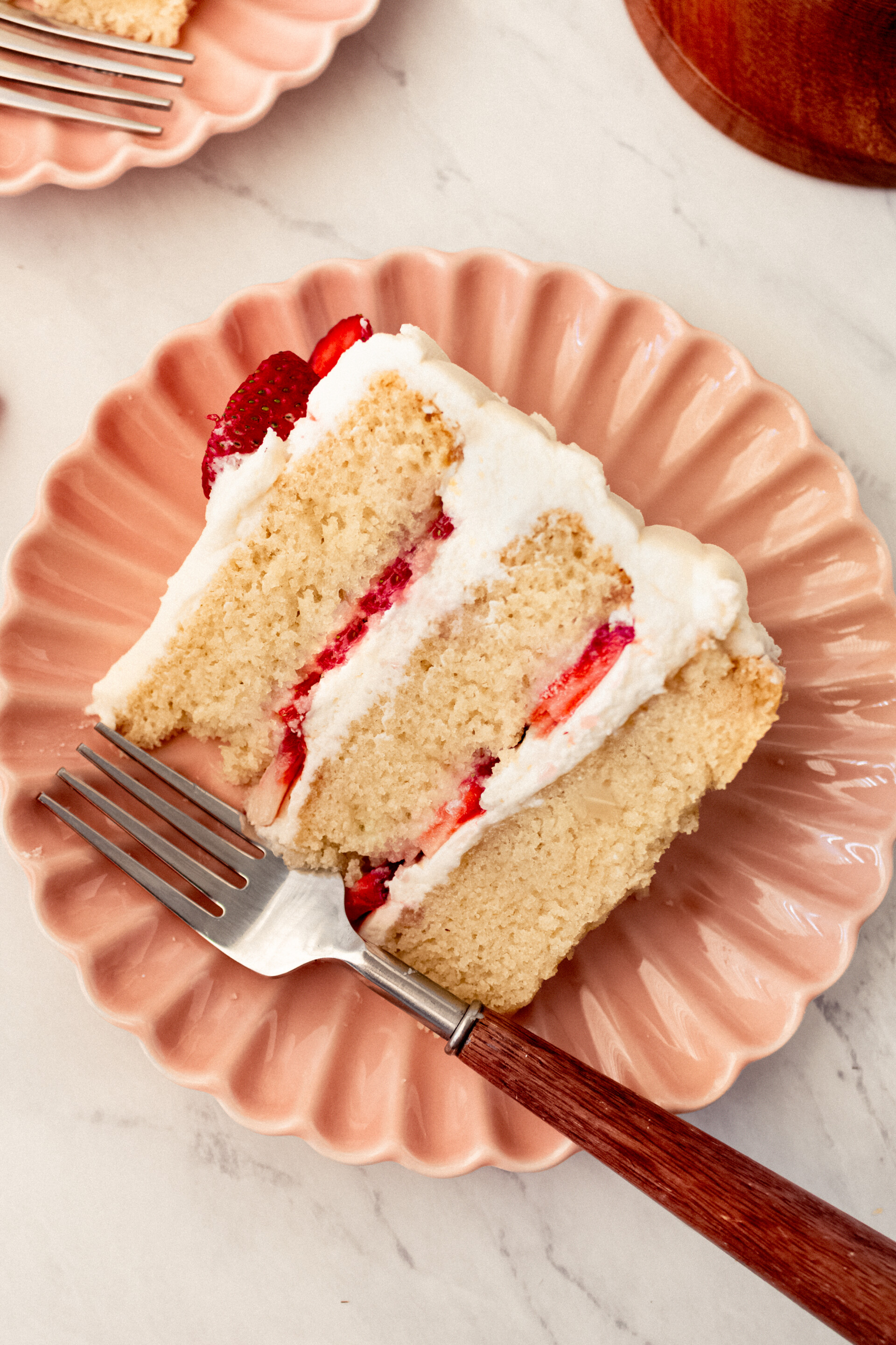 A slice of cake on a plate with a fork.