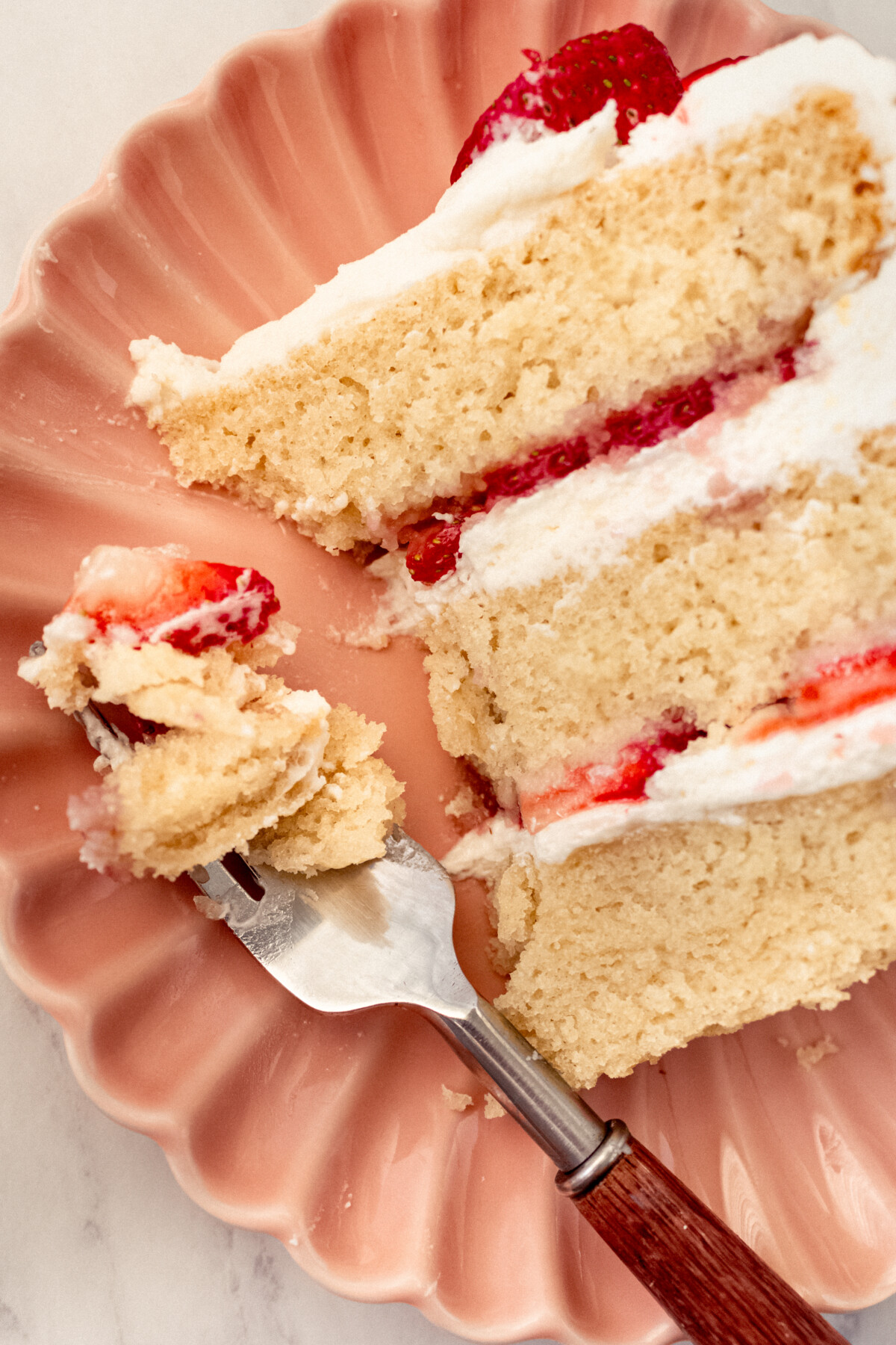 A slice of cake with a bite taken out of it.