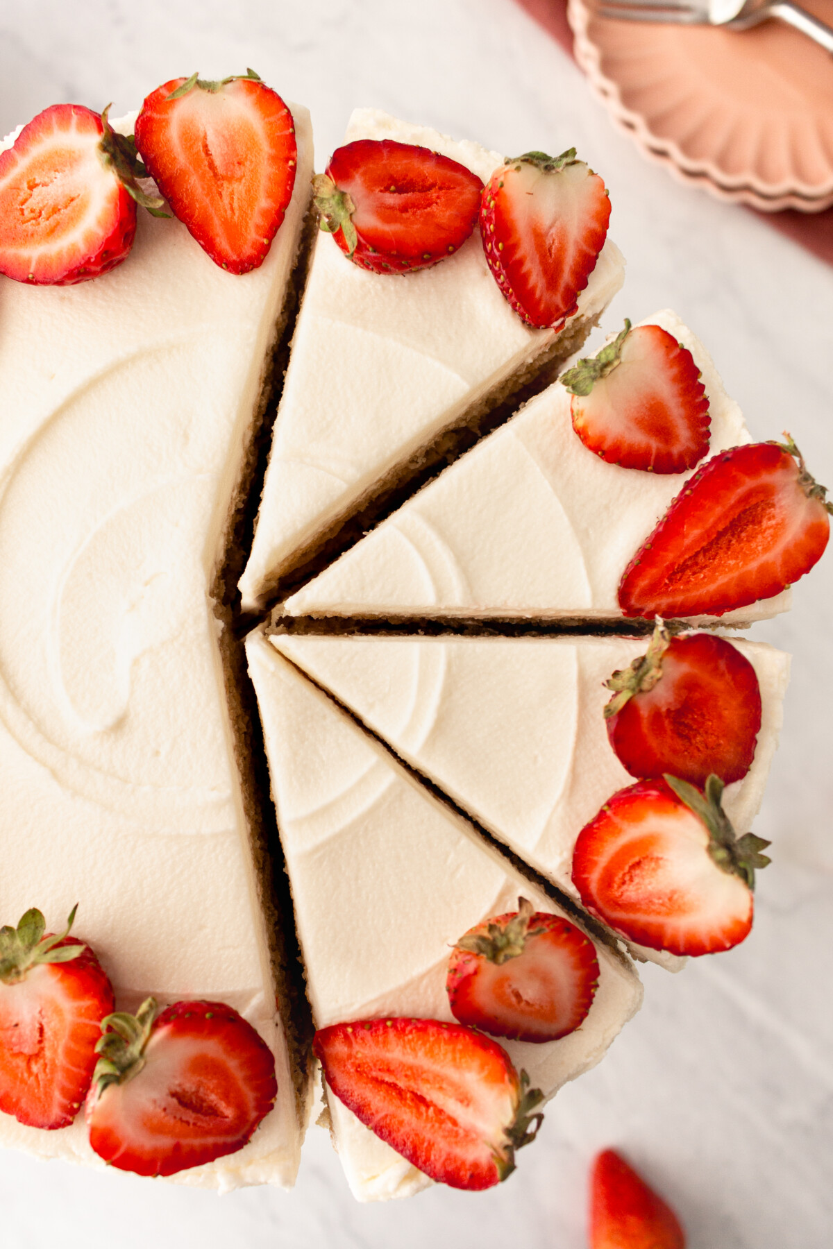 An overhead picture of a cake with slices cut into it.