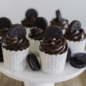 A cake stand full of chocolate cupcakes.