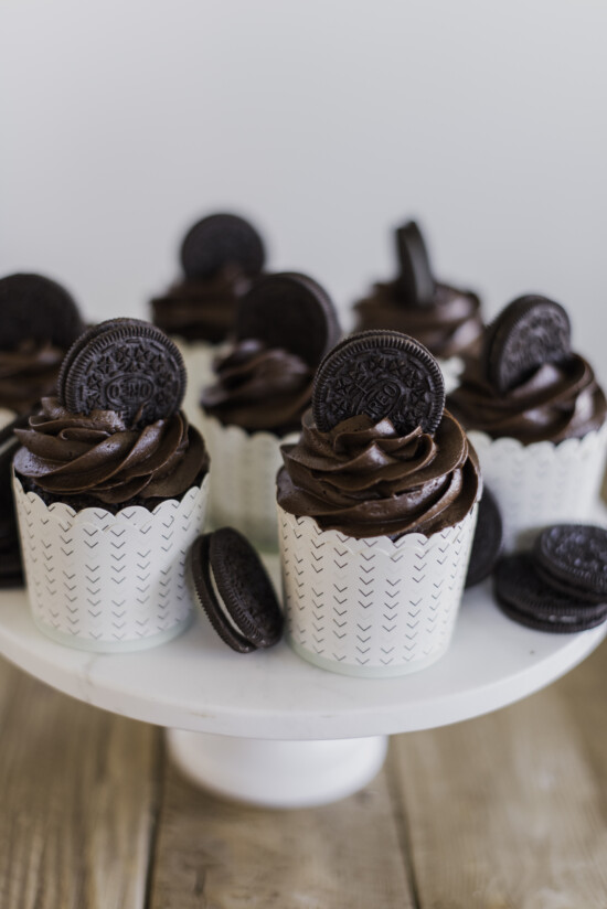 A cake stand full of chocolate cupcakes.