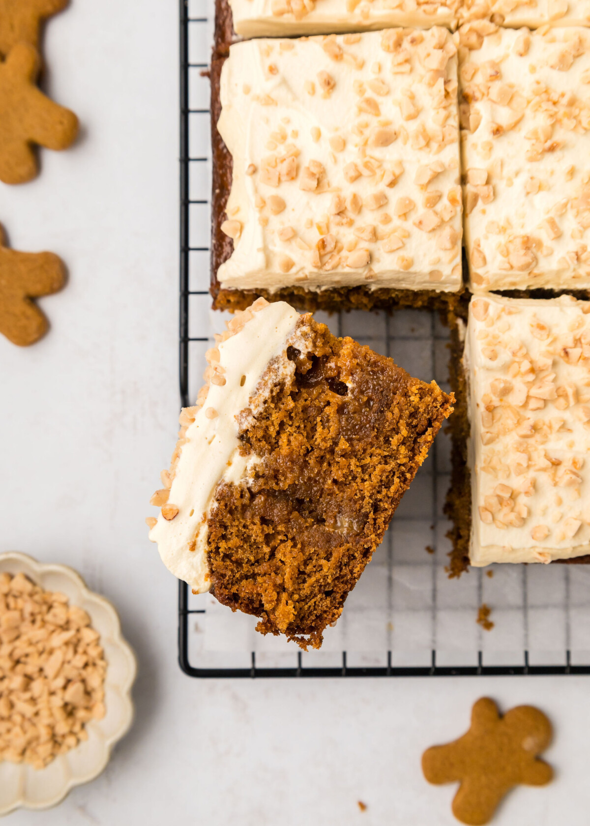 A sheet cake cut into slices on a cooling rack.